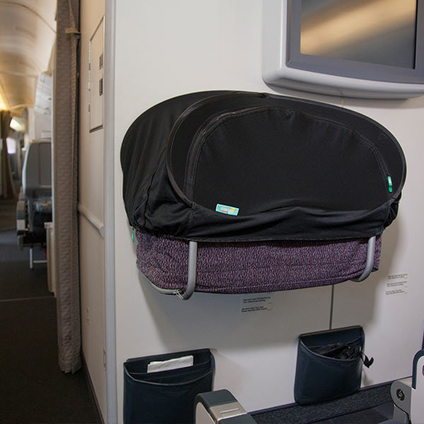 A CoziGo sleep cover fitted to an airline bassinet