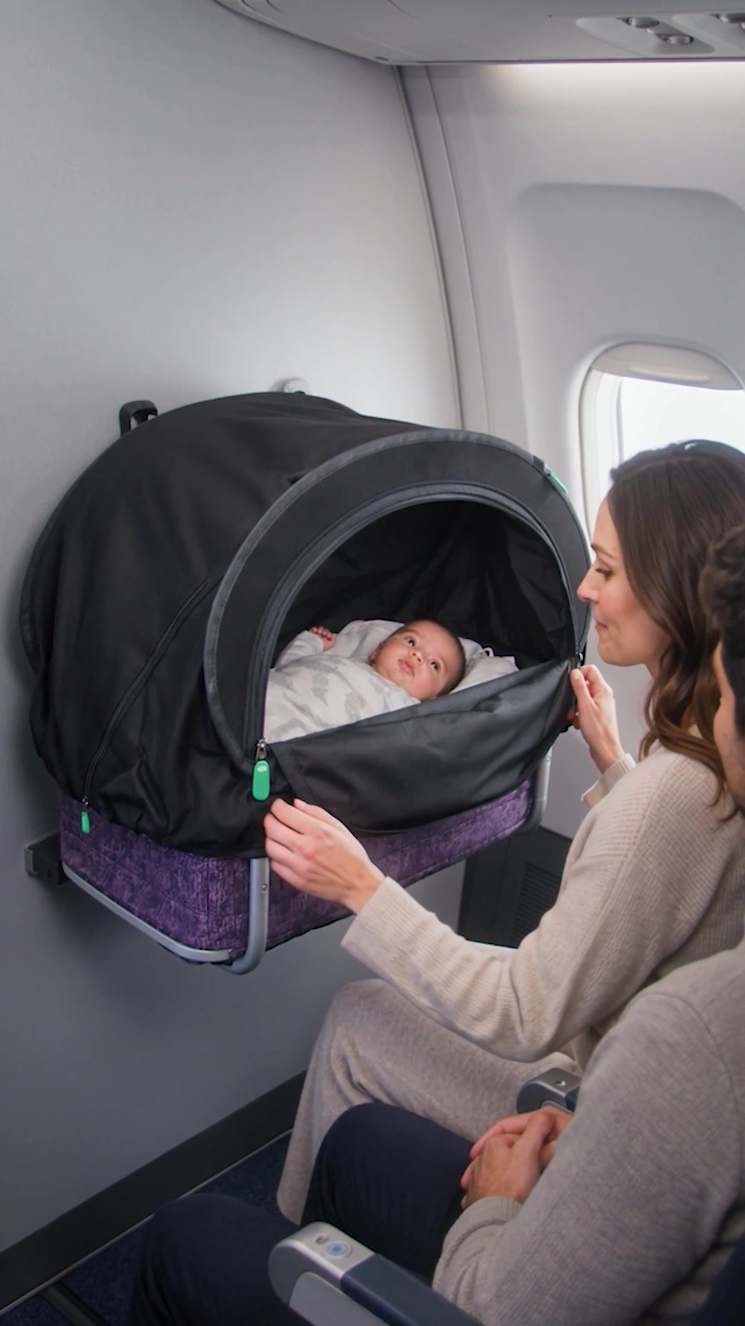 CoziGo on an airline bassinet and stroller, with a mum and sibling at the airport.