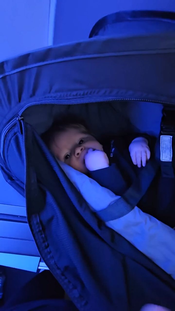 From plane to pram - he slept in his dark, calm nap space.